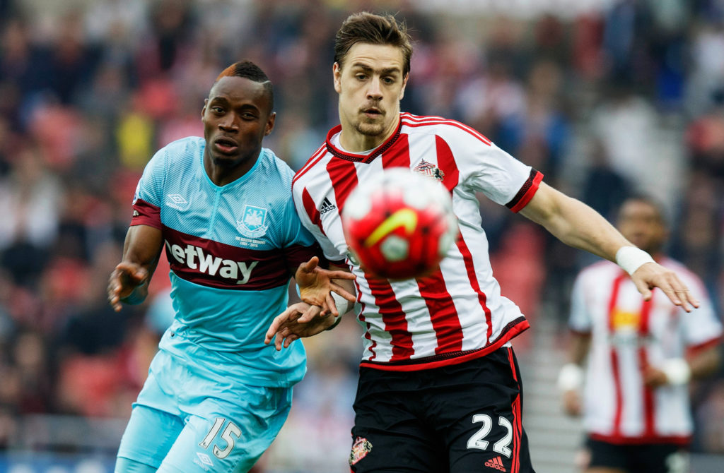 SUNDERLAND, ENGLAND - OCTOBER 03: Sebastian Coates of Sunderland and Diafra Sakho of West Ham United compete for the ball during the Barclays Premier League match between Sunderland and West Ham United at the Stadium of Light in Sunderland, United Kingdom. (Photo by Steve Welsh/Getty Images)