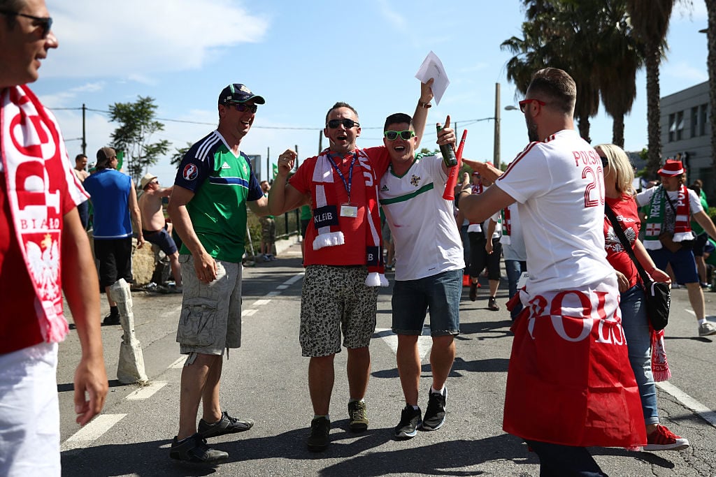 NICE, FRANCE - JUNE 12:  Poland and Northern Ireland fans chant and dance as they arrive to watch their national teams play in the group stage of the UEFA Euro 2016 football tournament at Allianz Riviera Stadium on June 12, 2016 in Nice, France. Football fans from around Europe have descended on France for the UEFA Euro 2016 football tournament.  (Photo by Carl Court/Getty Images)