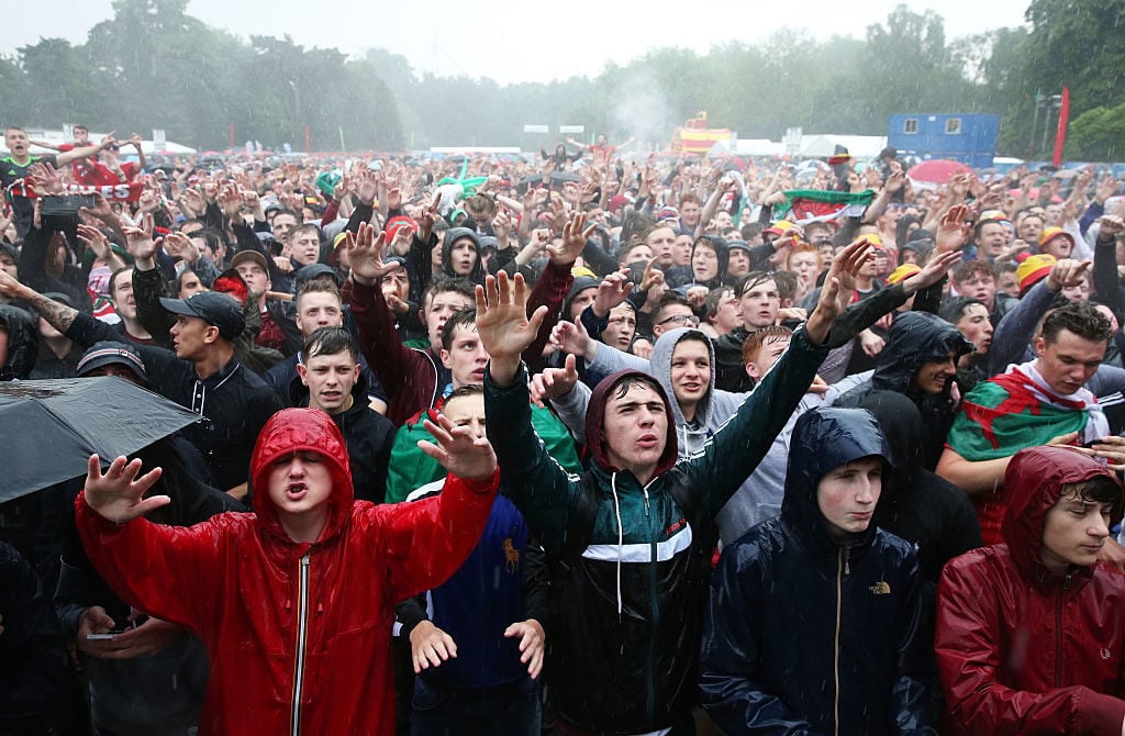 CARDIFF, UNITED KINGDOM - JUNE 16:  Fans cheer ahead of the UEFA EURO 2016 Group B match between England and Wales at the Cardiff Fanzone in Bute Park on June 16, 2016 in Cardiff, United Kingdom.  (Photo by Matt Cardy/Getty Images)