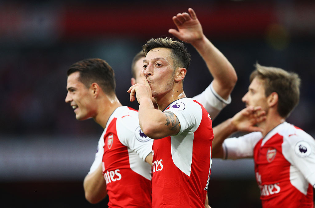 LONDON, ENGLAND - SEPTEMBER 24: Mesut Ozil of Arsenal (C) celebrates scoring his sides third goal with his team mates during the Premier League match between Arsenal and Chelsea at the Emirates Stadium on September 24, 2016 in London, England. (Photo by Paul Gilham/Getty Images)