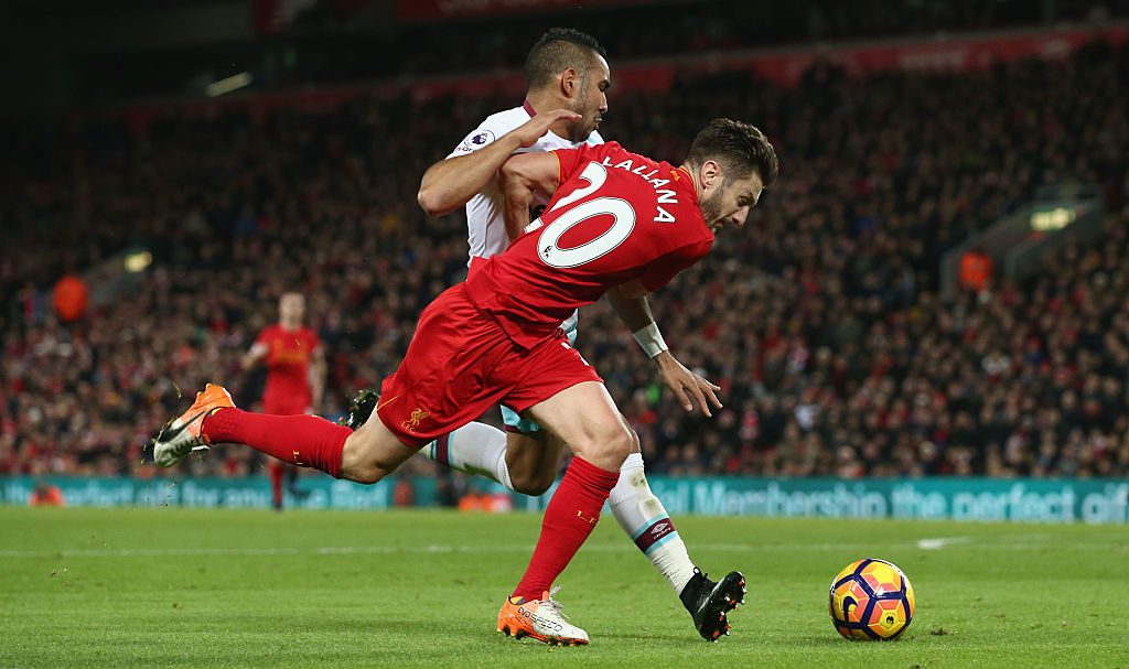 LIVERPOOL, ENGLAND - DECEMBER 11: Roberto Firmino of Liverpool is challenged by Dimitri Payet of West Ham United in the penalty area during the Premier League match between Liverpool and West Ham United at Anfield on December 11, 2016 in Liverpool, England. (Photo by Jan Kruger/Getty Images)