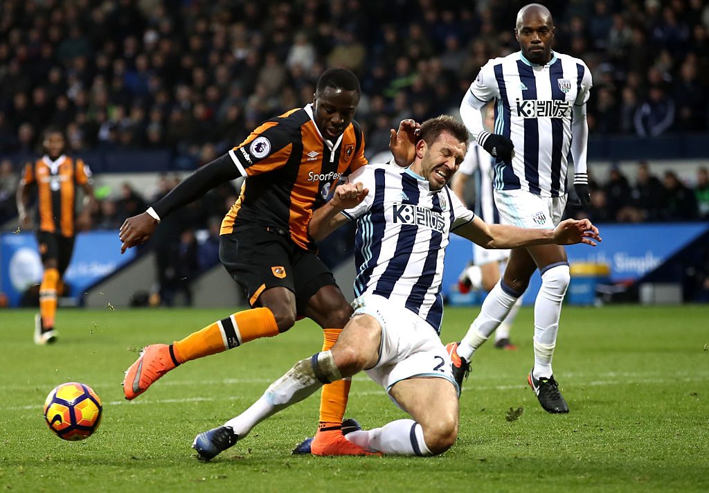 WEST BROMWICH, ENGLAND - JANUARY 02: Adama Diomande of Hull City (L) shoots while Gareth McAuley of West Bromwich Albion (R) attempts to block during the Premier League match between West Bromwich Albion and Hull City at The Hawthorns on January 2, 2017 in West Bromwich, England. (Photo by Julian Finney/Getty Images)