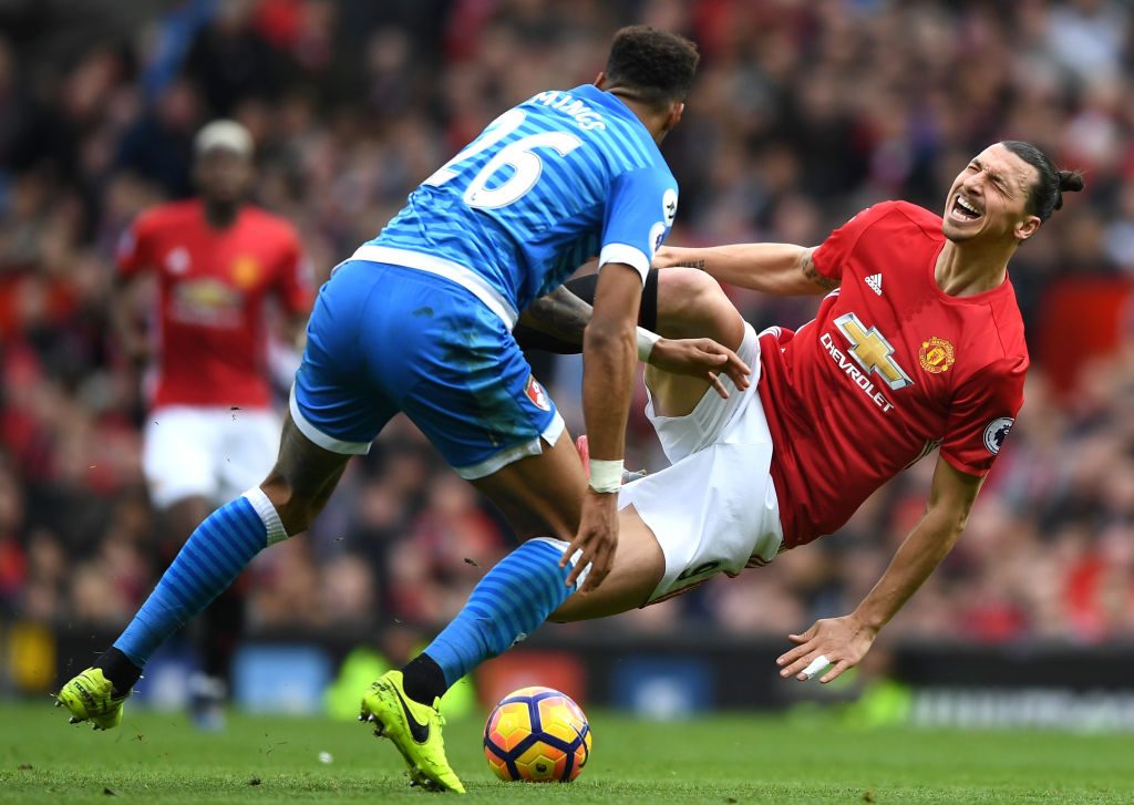 MANCHESTER, ENGLAND - MARCH 04: Zlatan Ibrahimovic of Manchester United (R) is challenged by Tyrone Mings of AFC Bournemouth (L) during the Premier League match between Manchester United and AFC Bournemouth at Old Trafford on March 4, 2017 in Manchester, England. (Photo by Shaun Botterill/Getty Images)