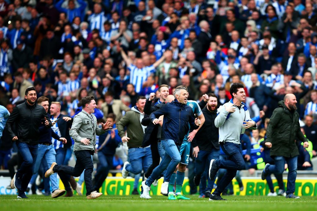 BRIGHTON, ENGLAND - APRIL 17:  Brighton & Hove Albion fans celebrate on the pitch after their team's victory in the Sky Bet Championship match between Brighton & Hove Albion and Wigan Athletic at Amex Stadium on April 17, 2017 in Brighton, England.  (Photo by Dan Istitene/Getty Images)