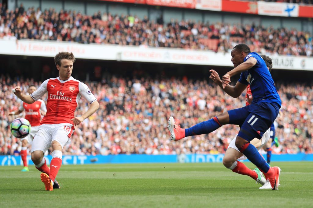 LONDON, ENGLAND - MAY 07: Anthony Martial of Manchester United shoots as Nacho Monreal of Arsenal attempts to block during the Premier League match between Arsenal and Manchester United at the Emirates Stadium on May 7, 2017 in London, England. (Photo by Richard Heathcote/Getty Images)