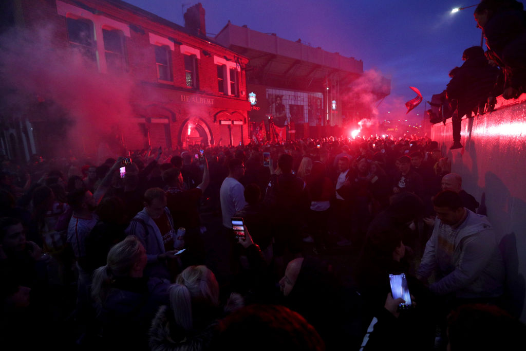 Fans Celebrate As Liverpool FC Lift The Premiership Trophy At Anfield