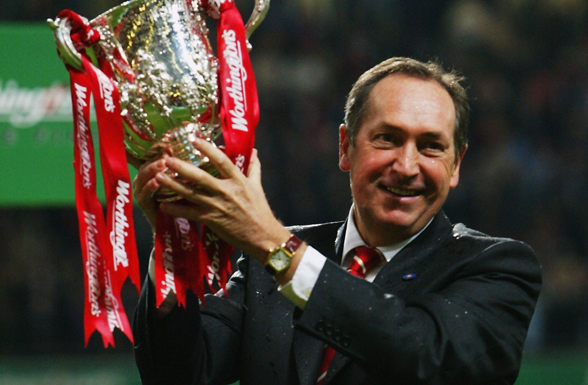 Liverpool manager Gerard Houllier poses with the trophy