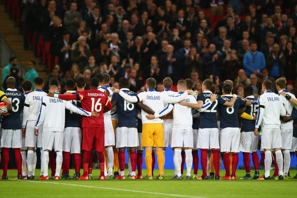 LONDON, ENGLAND - NOVEMBER 17: Both teams stand together for a moment of applause prior to the International Friendly match between England and France at Wembley Stadium on November 17, 2015 in London, England. (Photo by Clive Rose/Getty Images)