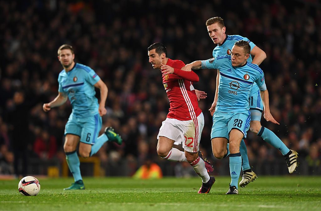 MANCHESTER, ENGLAND - NOVEMBER 24:  Henrikh Mkhitaryan of Manchester United evades Jens Toornstra (28) and Wessel Dammers of Feyenoord (31) during the UEFA Europa League Group A match between Manchester United FC and Feyenoord at Old Trafford on November 24, 2016 in Manchester, England.  (Photo by Gareth Copley/Getty Images)