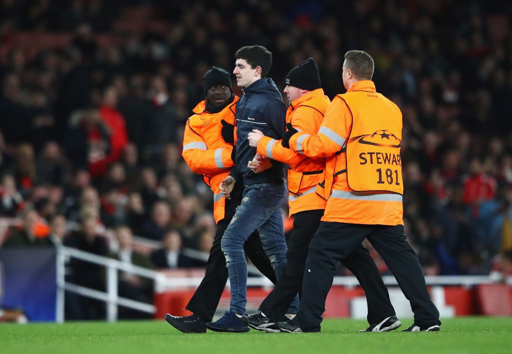 LONDON, ENGLAND - MARCH 07:  A pitch invader is escorted from the pitch during the UEFA Champions League Round of 16 second leg match between Arsenal FC and FC Bayern Muenchen at Emirates Stadium on March 7, 2017 in London, United Kingdom.  (Photo by Clive Mason/Getty Images)